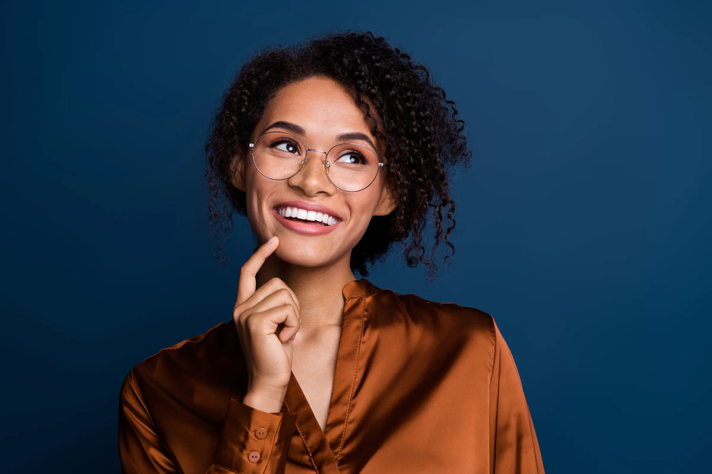 Smiling patient wearing glasses on a blue background